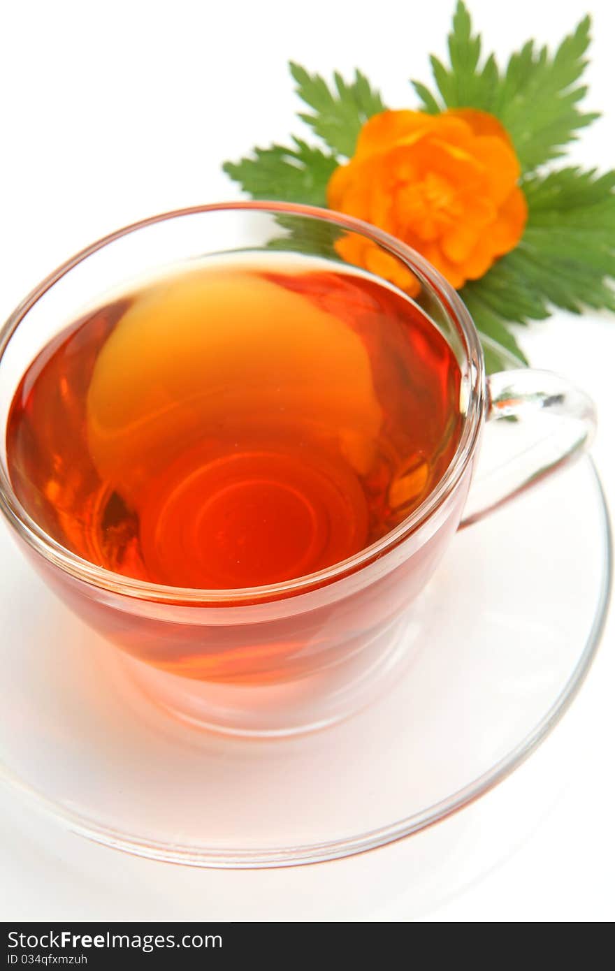 Cup with tea and a flower on a white background