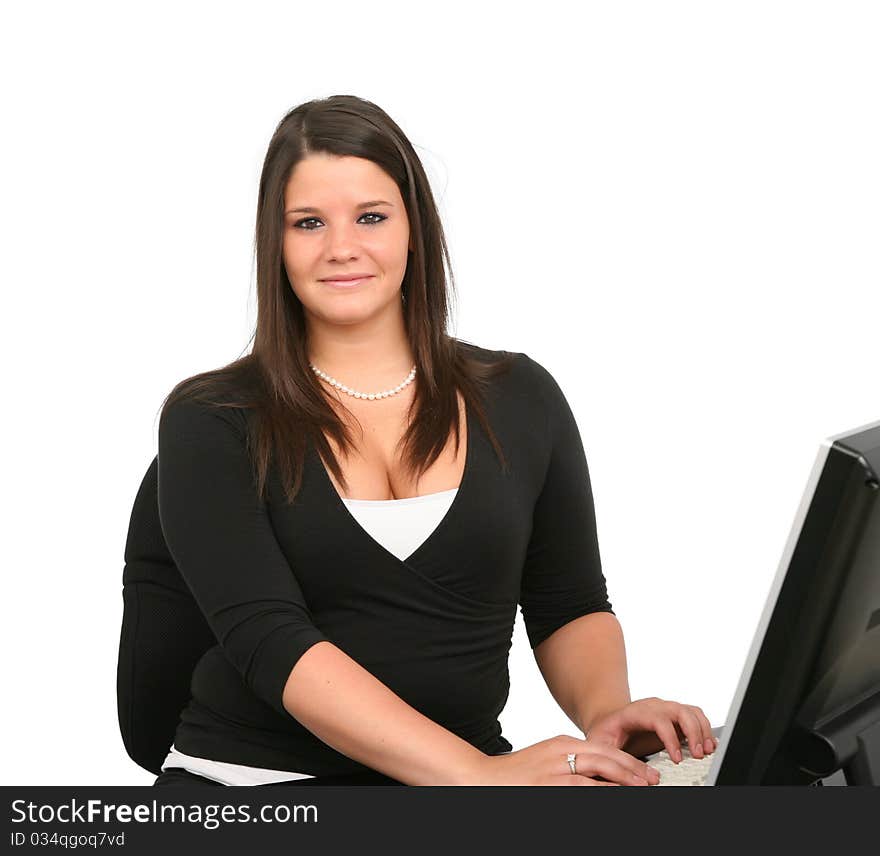 A cheerful young woman working on her computer. A cheerful young woman working on her computer.