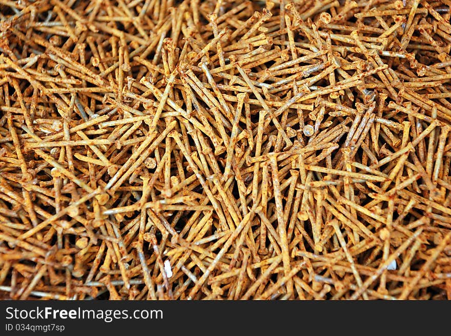 Background of the old rusty nails, close-up. Focus is on the nails in the front and falls off a little in the back