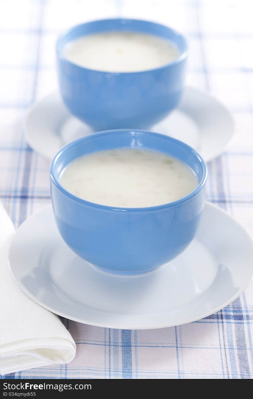 Two blue bowls of onion pureed soup