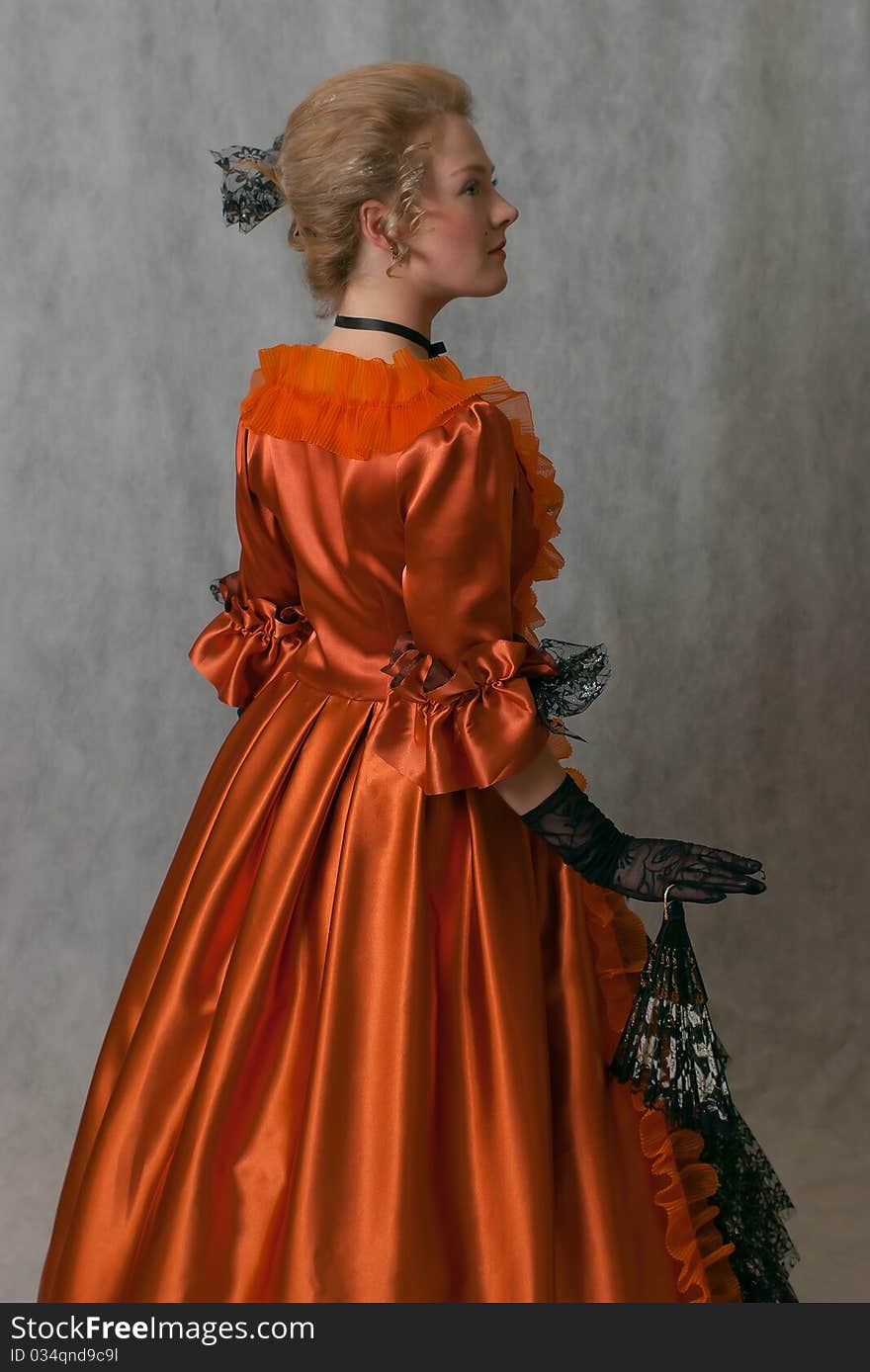 Studio shot of standing girl with baroque dress and hairstyle. Studio shot of standing girl with baroque dress and hairstyle