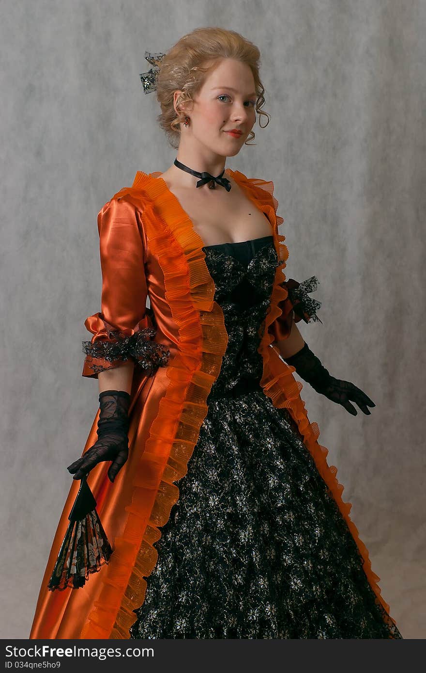 Studio shot of standing girl with baroque dress and hairstyle. Studio shot of standing girl with baroque dress and hairstyle