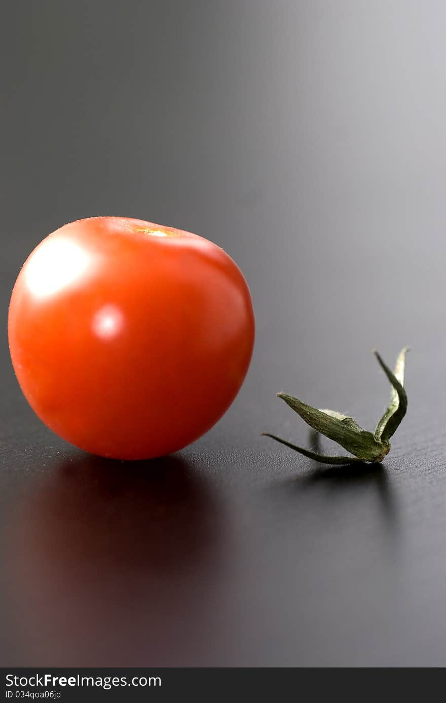 Small cherry tomato with a branch