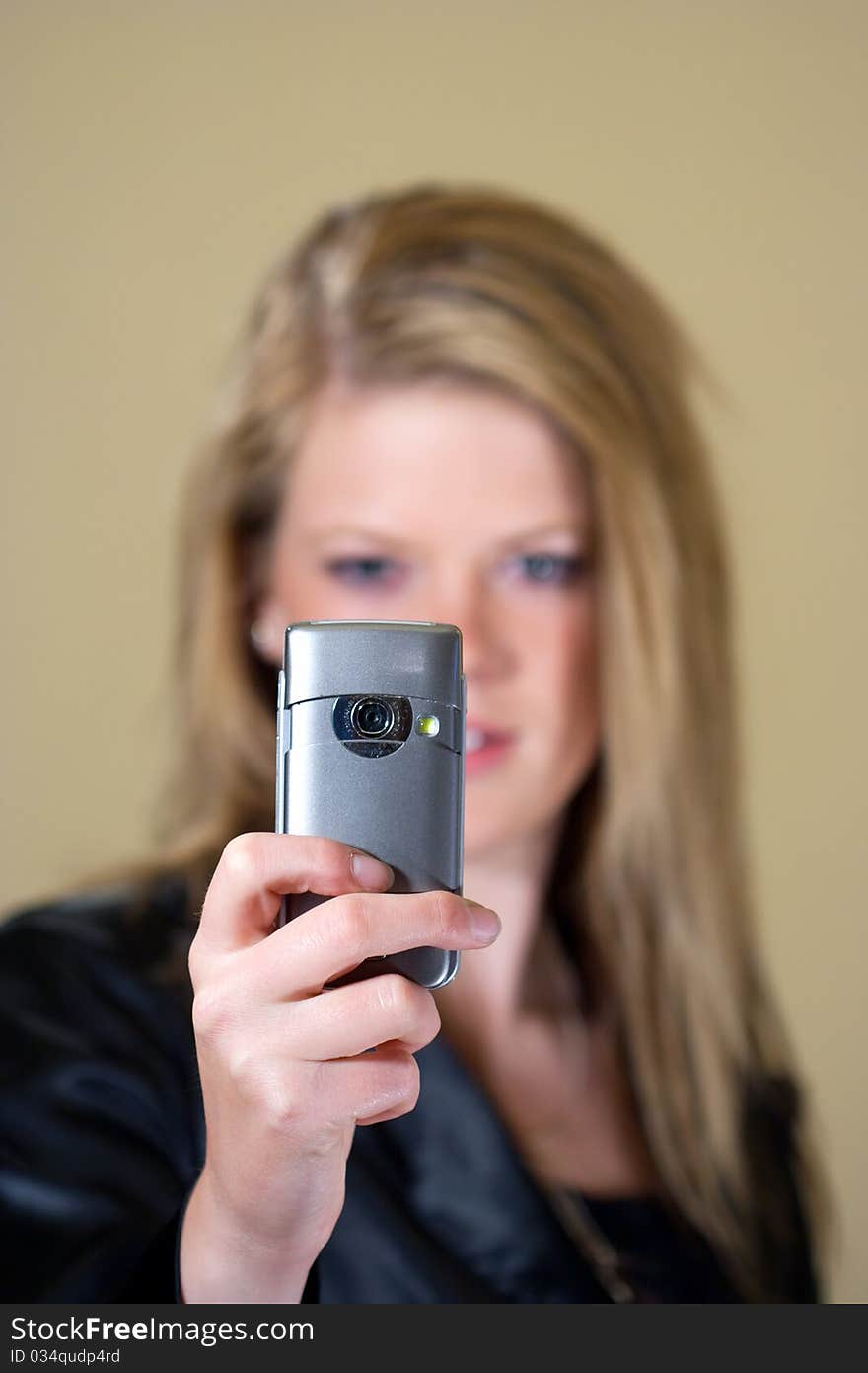 Teen girl taking a photo with her mobile phone