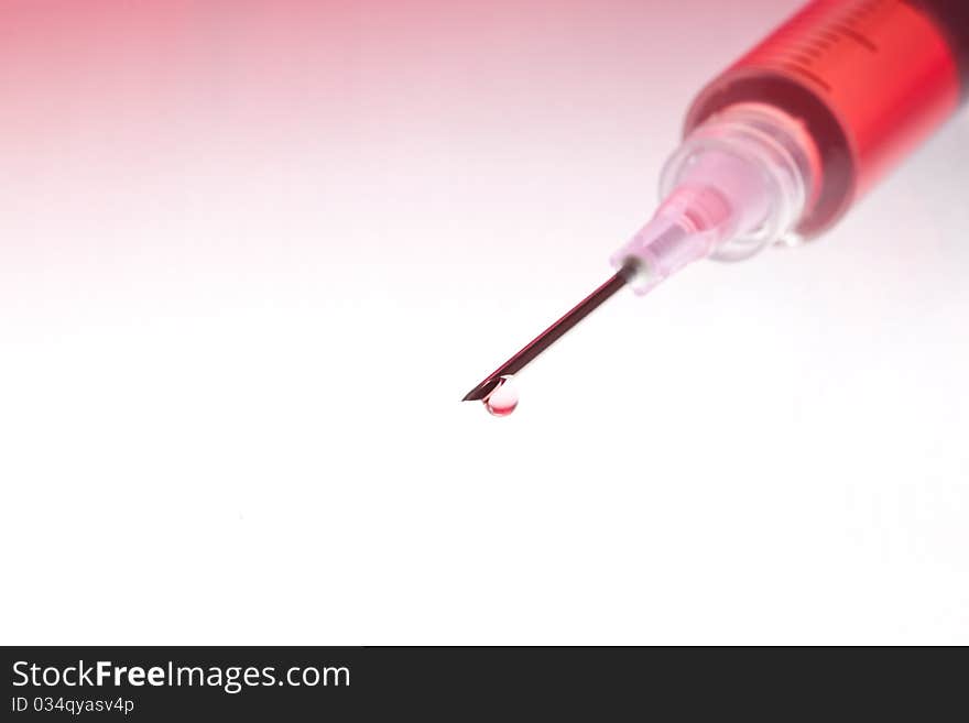 Red medication with colorful background. Lit from below, blended red-colored background.