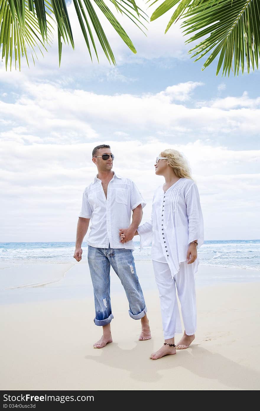 Portrait of young nice couple having good time on the beach