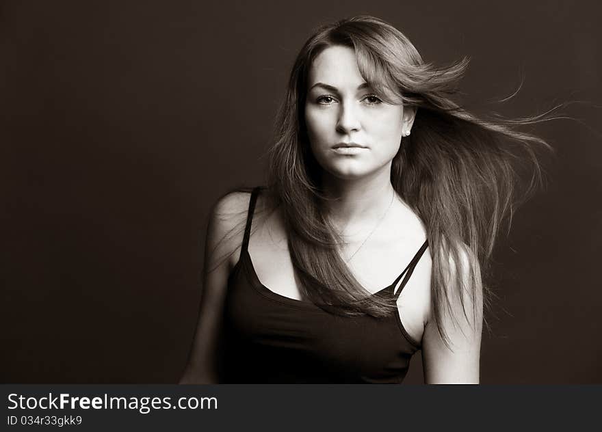 Attractive red woman with uncurl hairs against brown background