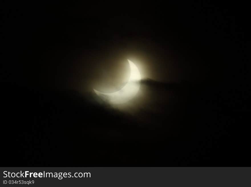 Partial Eclipse of the Sun with clouds