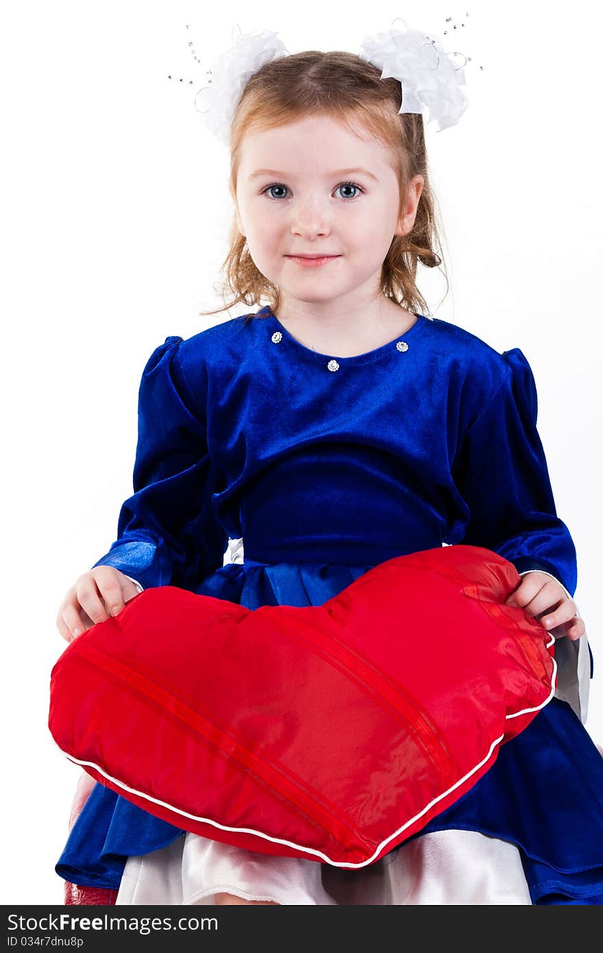 Beautiful girl sitting holding a red heart. Beautiful girl sitting holding a red heart