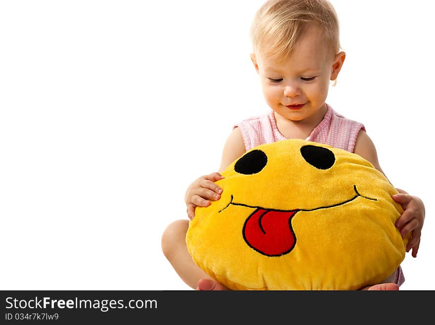 Beautiful baby girl holding a pillow