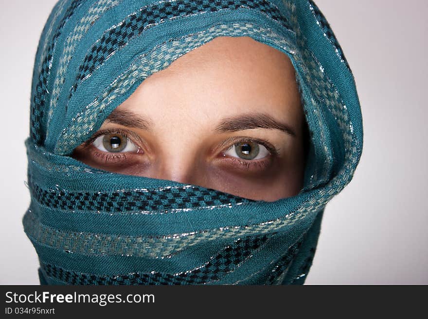 Portrait of charming European woman with shawl. Artistic selective focus on eyes. Portrait of charming European woman with shawl. Artistic selective focus on eyes.