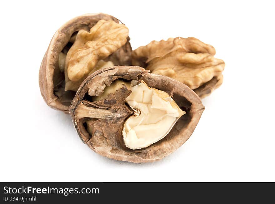 Walnut and a cracked walnut isolated on the white background