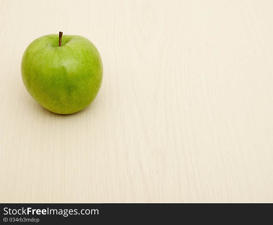 Green apple on wooden table