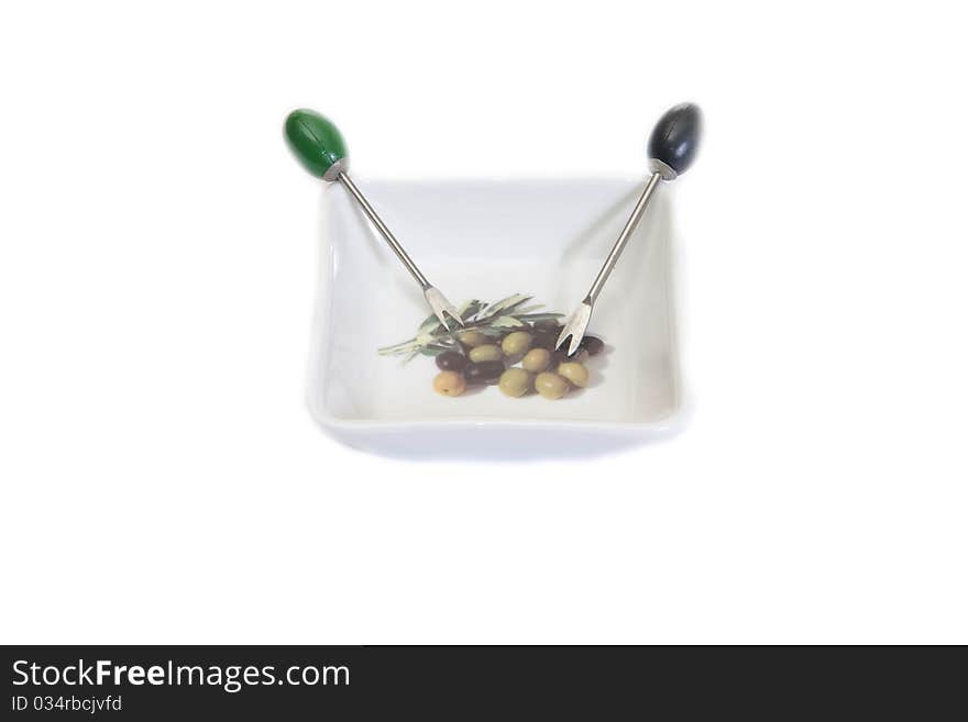 White plate for olives and plugs for berries, on a white background