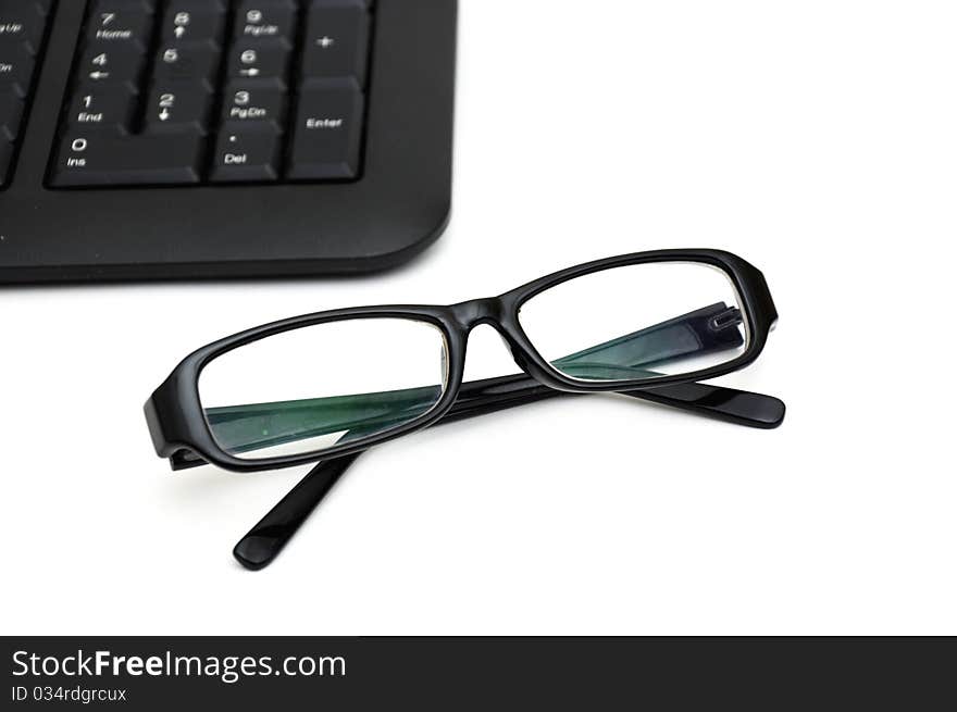 Glasses on computer keyboard