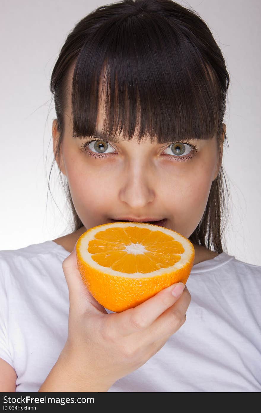 Attractive caucasion girl with orange in hands. Attractive caucasion girl with orange in hands