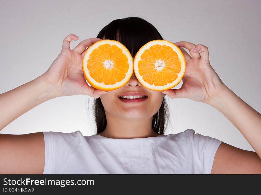 Attractive caucasion girl with orange in hands. Attractive caucasion girl with orange in hands