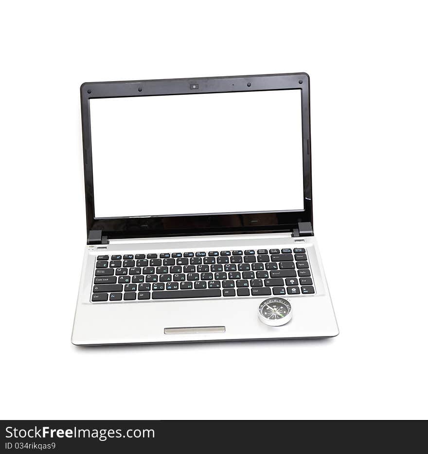 Compass on the laptop keyboard isolated on a white background