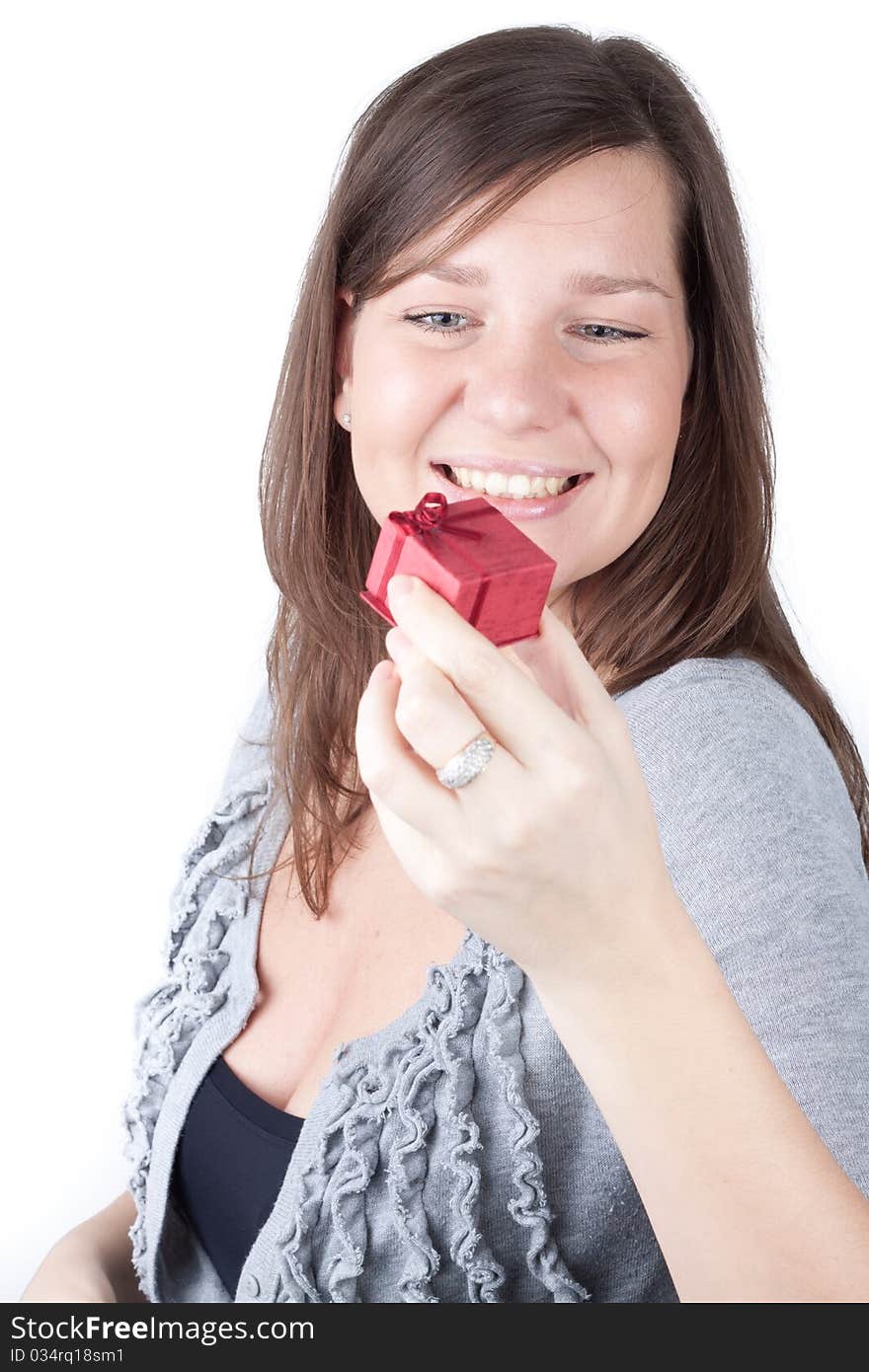 Portrait of a charming young girl on a white background holding valentine gift. Portrait of a charming young girl on a white background holding valentine gift