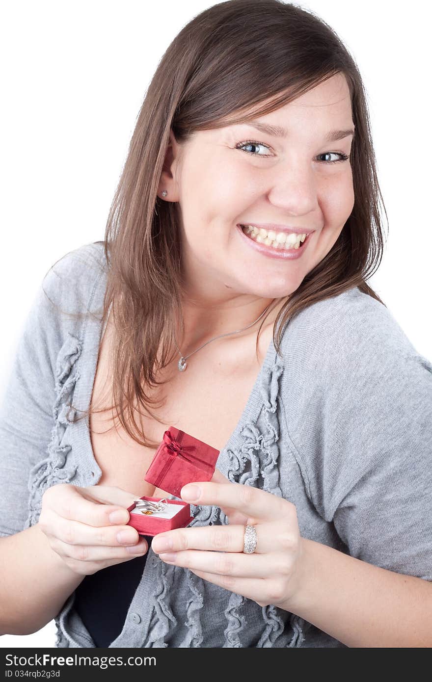 Portrait of a charming young girl on a white background holding valentine gift. Portrait of a charming young girl on a white background holding valentine gift