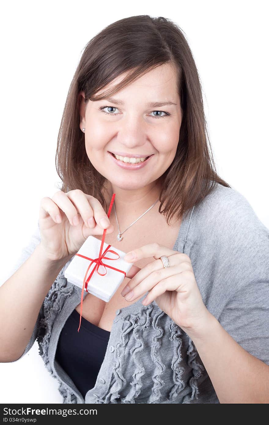 Portrait of a charming young girl on a white background holding valentine gift. Portrait of a charming young girl on a white background holding valentine gift