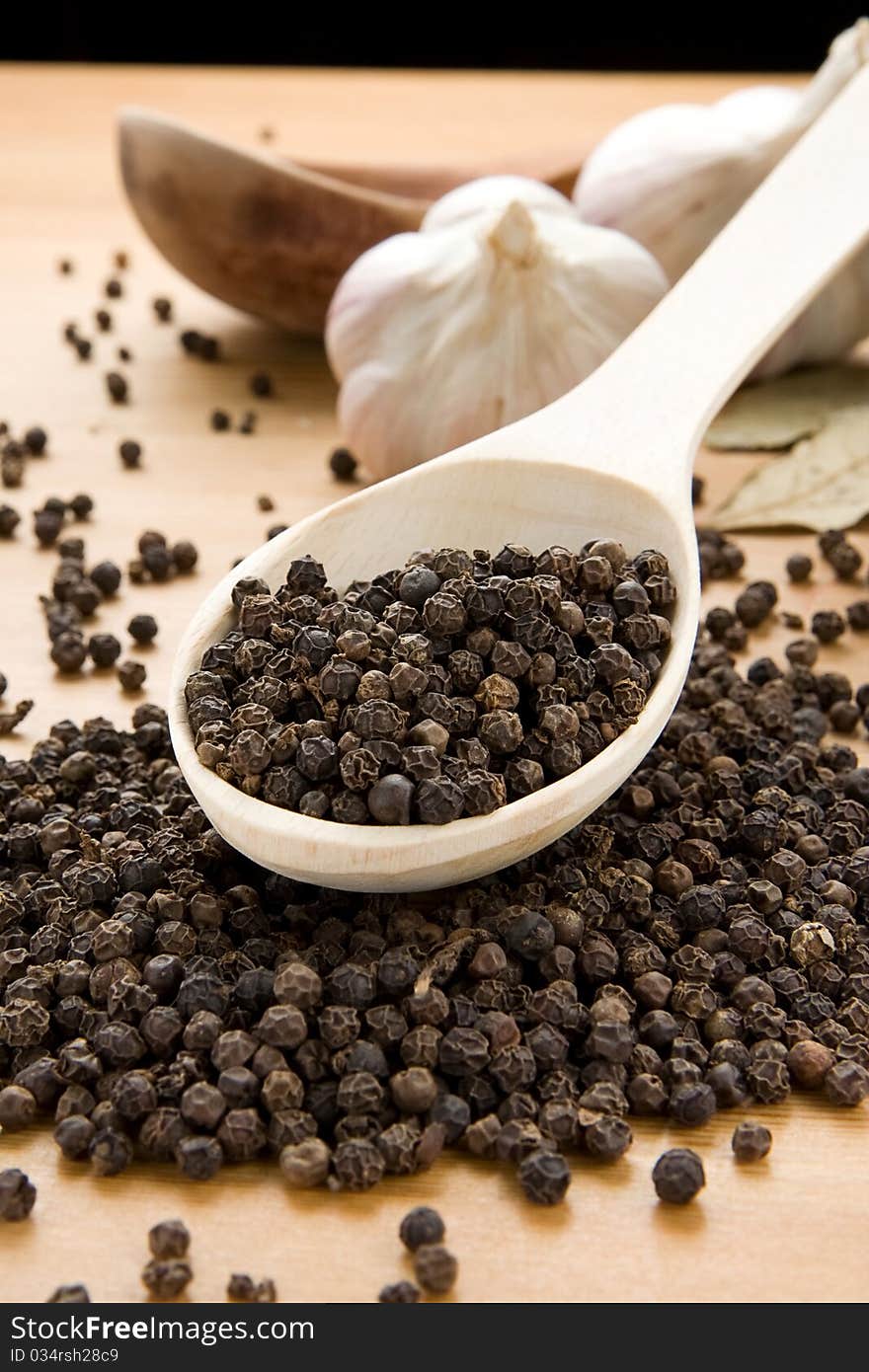 Garlic And Pepper On Wooden Spoon