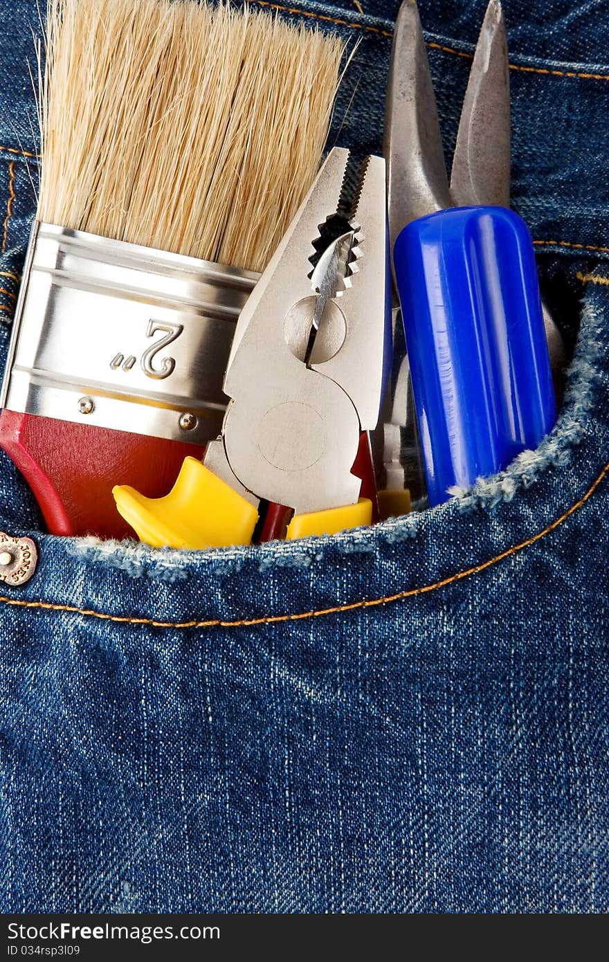 Tools and instruments in old blue jeans