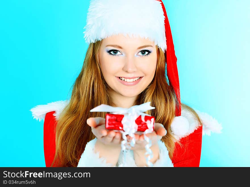 Beautiful young woman in Santa Claus clothes over Christmas background. Beautiful young woman in Santa Claus clothes over Christmas background.