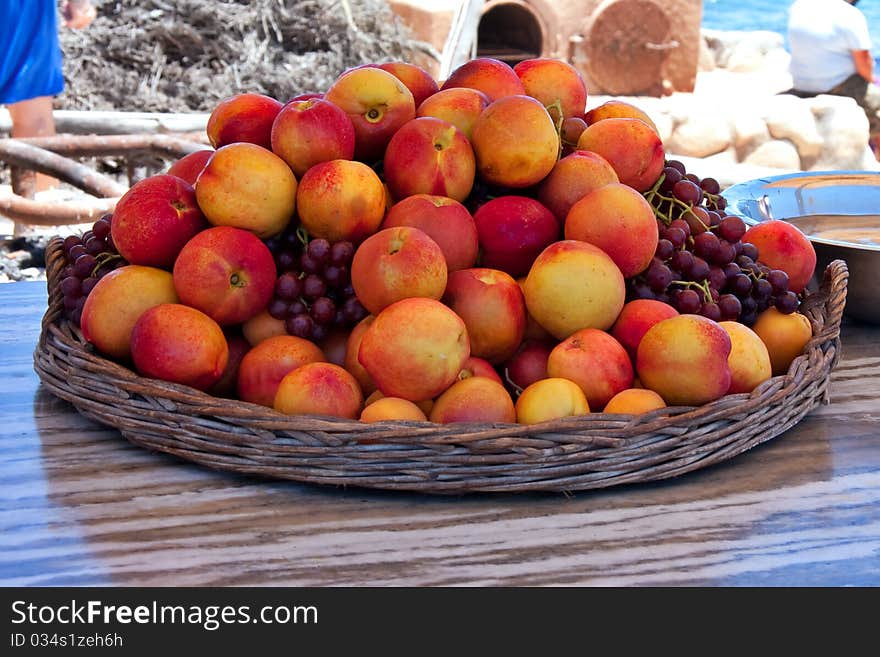 Large basket of peaches and grapes served at outdoor restaurant on the coast on westcoast of south africa, Lamberts Bay. Large basket of peaches and grapes served at outdoor restaurant on the coast on westcoast of south africa, Lamberts Bay