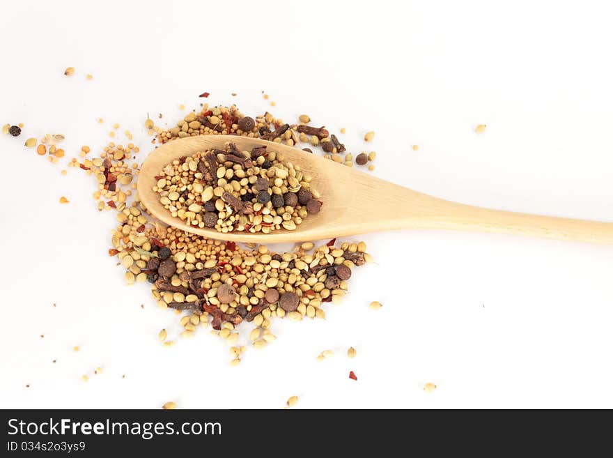 Pickling spice. Spices mixed over the spoon.