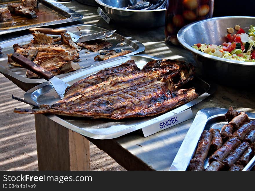 Freshly grilled snoek fish served at restaurant, traditional south african dish. Freshly grilled snoek fish served at restaurant, traditional south african dish