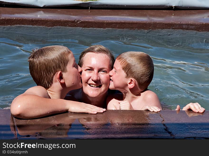 Mother and boys in pool