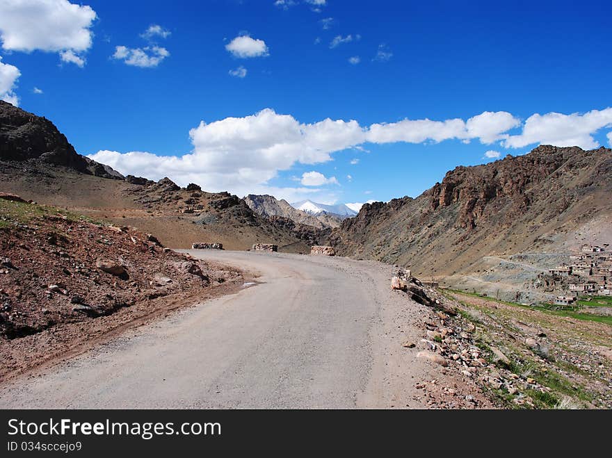 A concrete road leading to a top of a Himalayan mountain peak. A concrete road leading to a top of a Himalayan mountain peak.