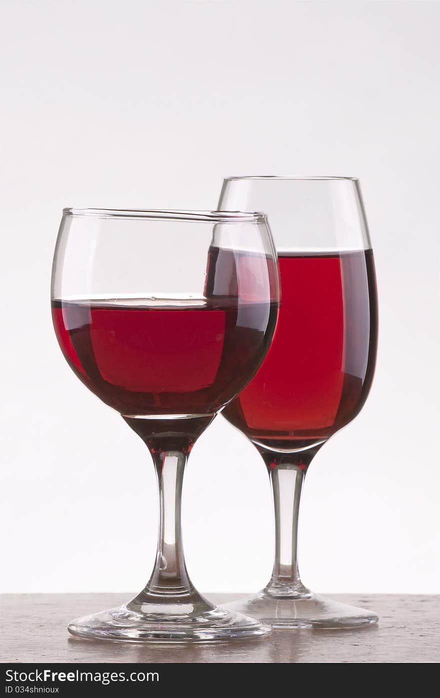 Two different glass of rose wine  with gray background