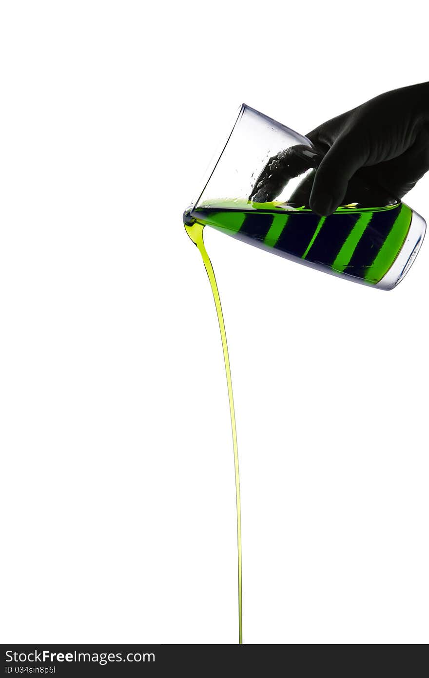 Green syrup pouring on white