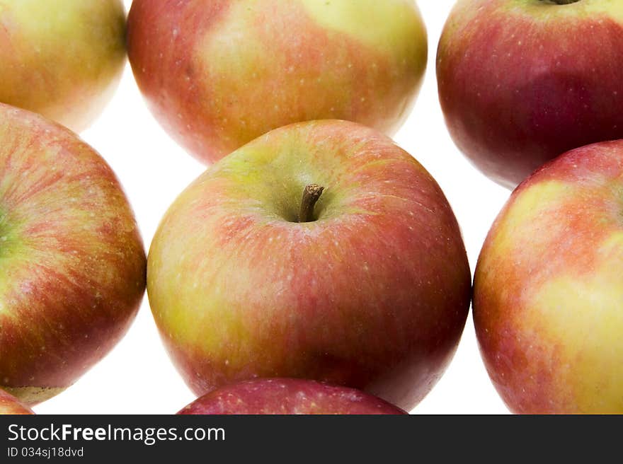 The red ripe apples combined in some numbers (on a white background, focus on the central apple). The red ripe apples combined in some numbers (on a white background, focus on the central apple)