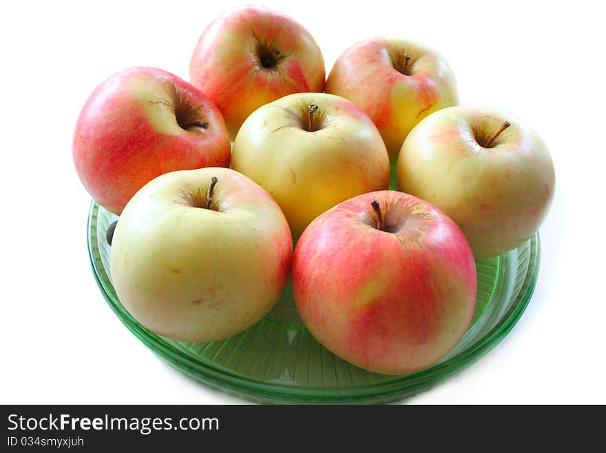 Fresh apples on the green plate isolated on white. Fresh apples on the green plate isolated on white