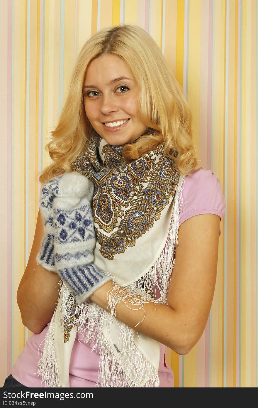 Close-up of an beautiful young Russian woman in mild winter mittens and a scarf. Happy. Close-up of an beautiful young Russian woman in mild winter mittens and a scarf. Happy