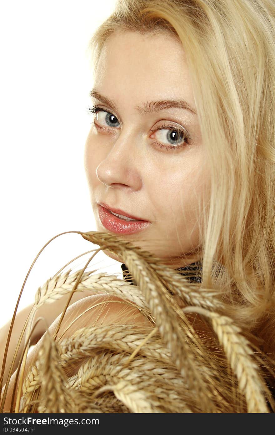 Close-up of a beautiful young woman with the ears of wheat. Isolated on a white background. Close-up of a beautiful young woman with the ears of wheat. Isolated on a white background