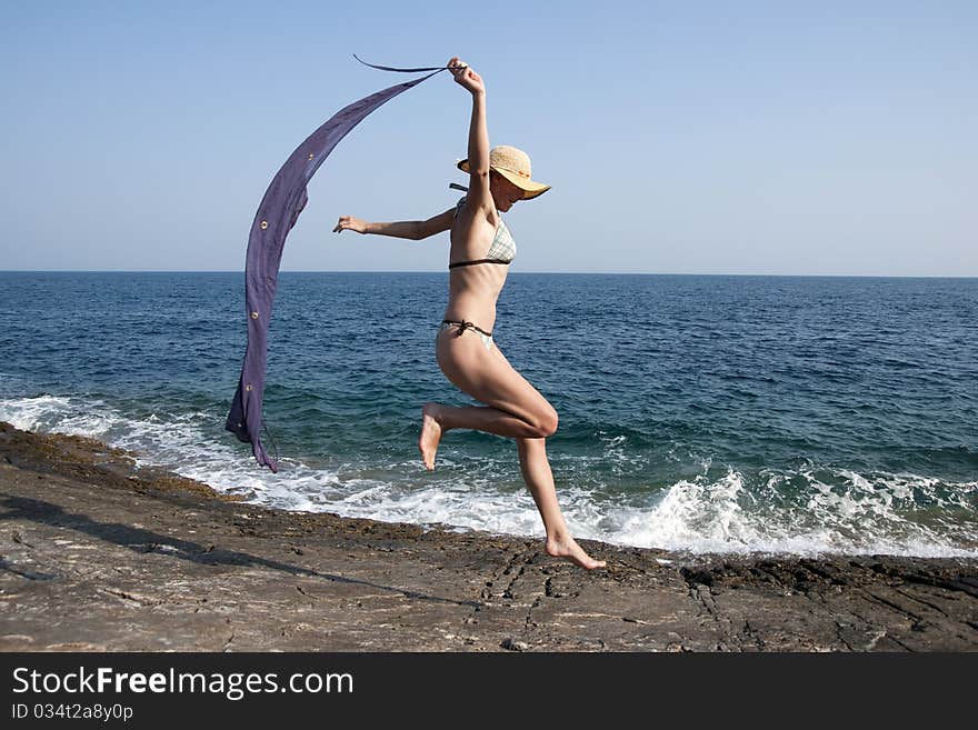 Happy woman running on the beach