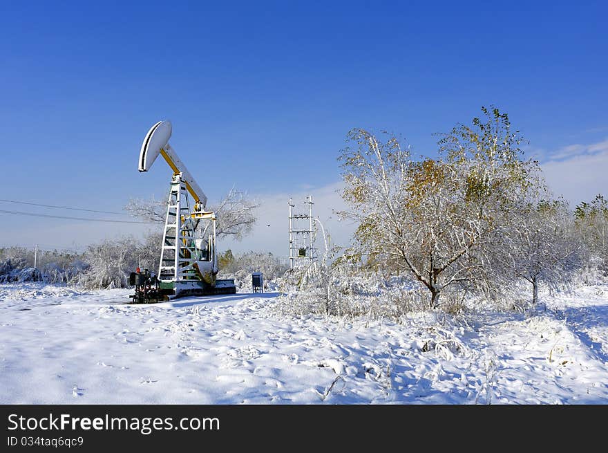 Cold winter, oil producing equipment is covered with snow. Cold winter, oil producing equipment is covered with snow