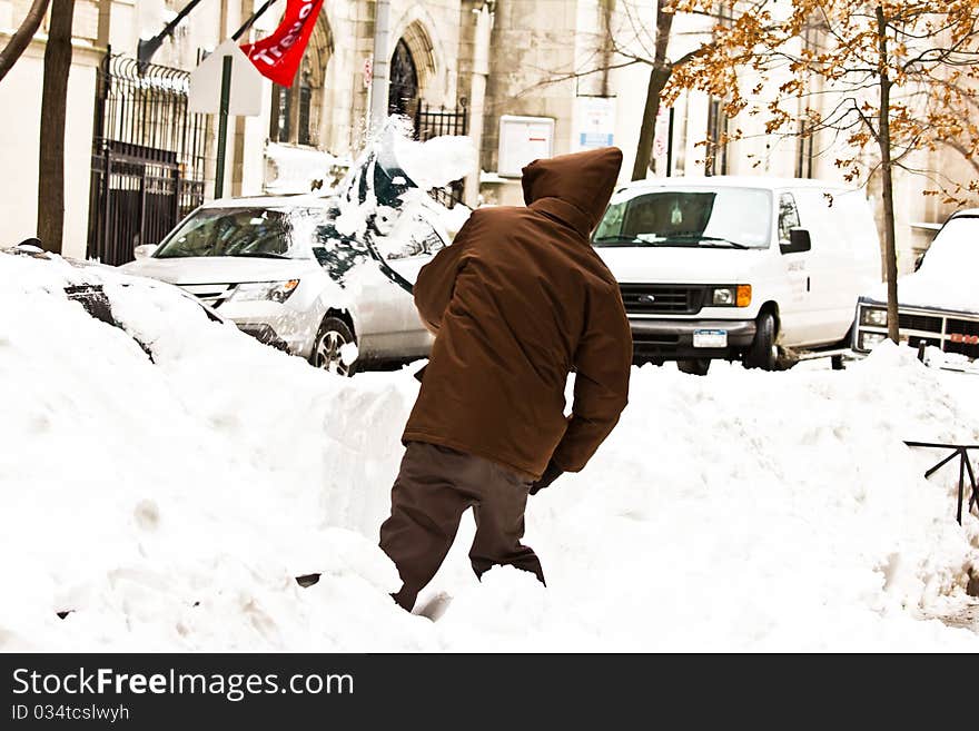 This is an image of a man clearing snow from his car. This is an image of a man clearing snow from his car.