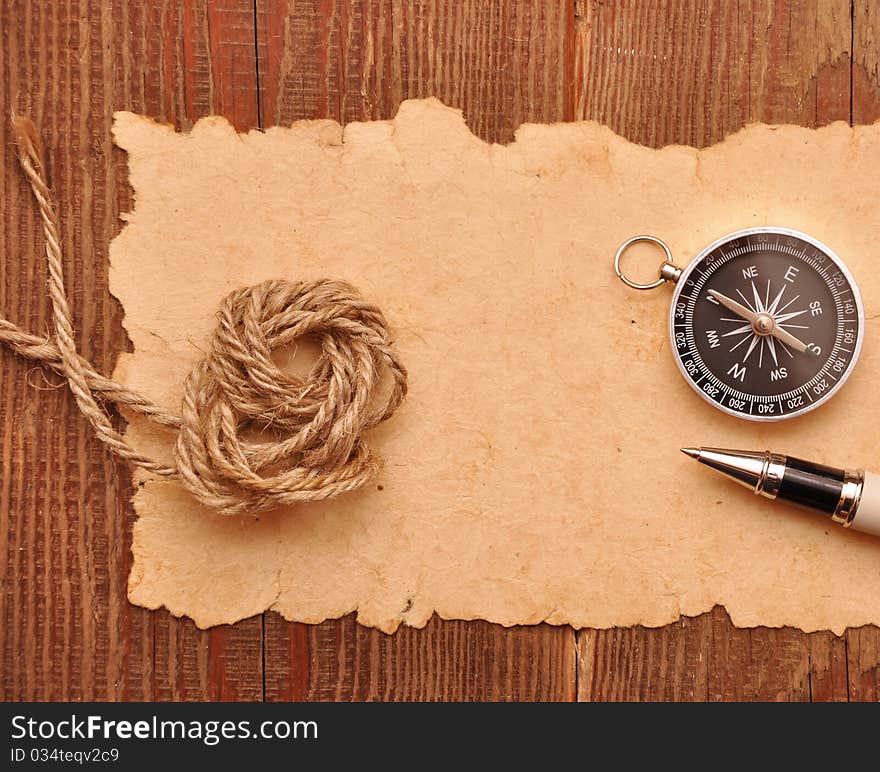 Compass pen and rope on grunge paper background. Compass pen and rope on grunge paper background