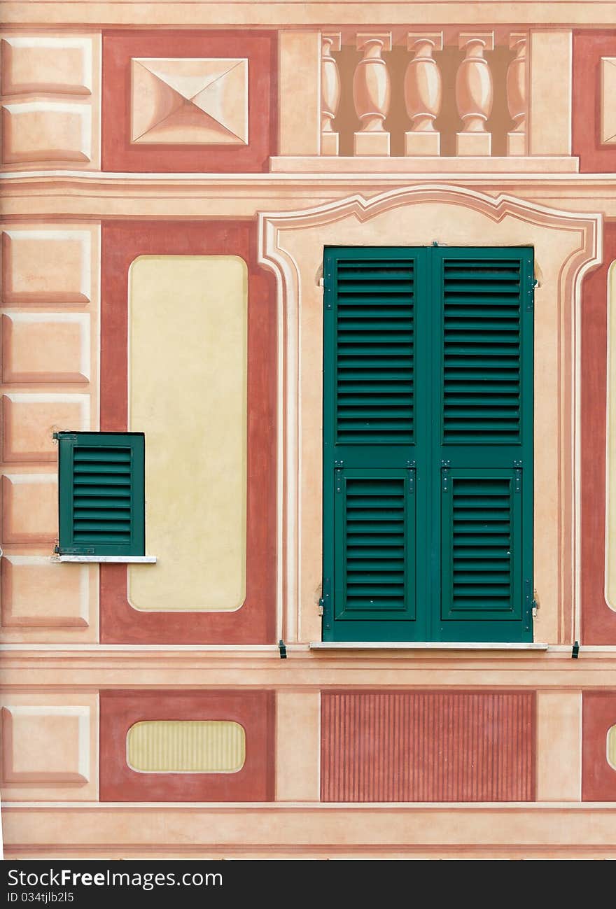 Decorated window on the facade of a building in the village of Camogli. Decorated window on the facade of a building in the village of Camogli