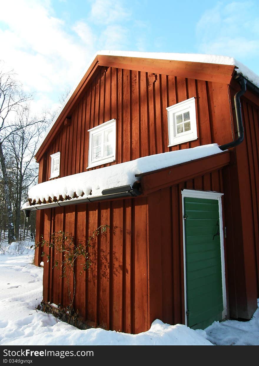 A detail of a typical swedish house with snow.