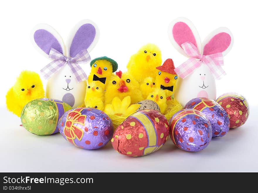 Easter Bunnies And Chicks With Eggs Over White