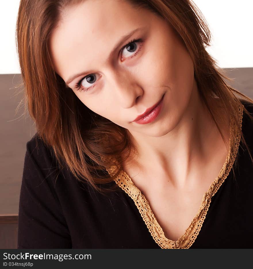 Beautiful woman sitting at the table turned back to camera