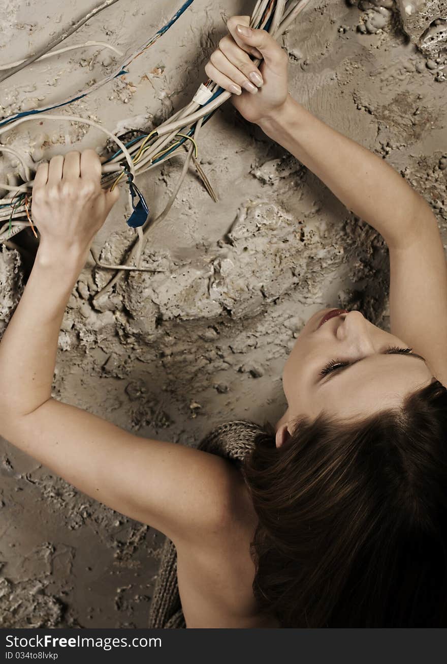 Woman pulling up grabbing the wires