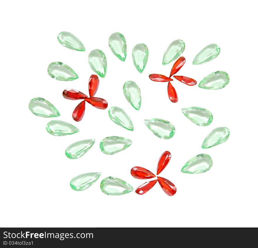 Glass and plastic bright red-green carat costume jewellery on a street market table. Good for background. Glass and plastic bright red-green carat costume jewellery on a street market table. Good for background.