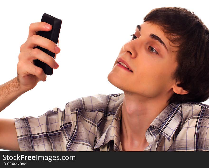 Young man types sms holding phone in hands on white background